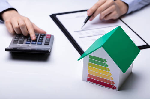 Small House With Energy Efficiency Rate On White Desk